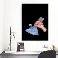 a hand holding a flask on a black background