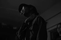 a black and white photo of a person in a dark room
