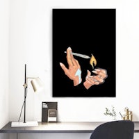 a hand holding a lighter in front of a desk